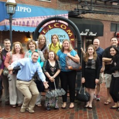 a group of people standing in front of a crowd posing for the camera