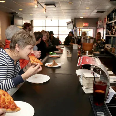 a group of people sitting at a table eating food