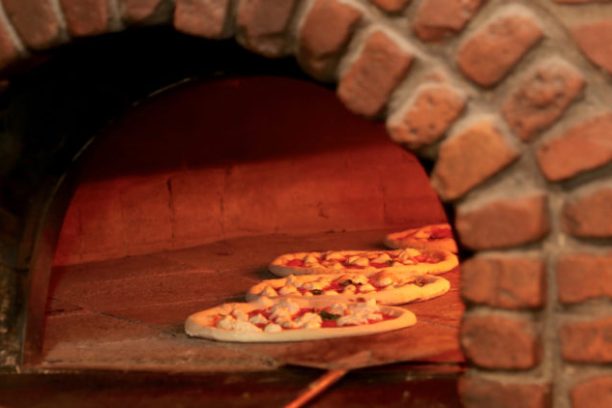 a pizza sitting on top of a wooden table