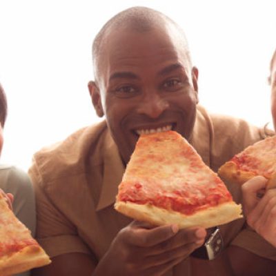 a woman eating a slice of pizza