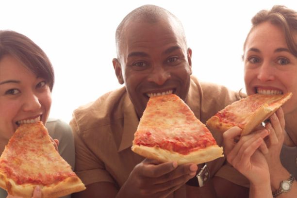 a woman eating a slice of pizza