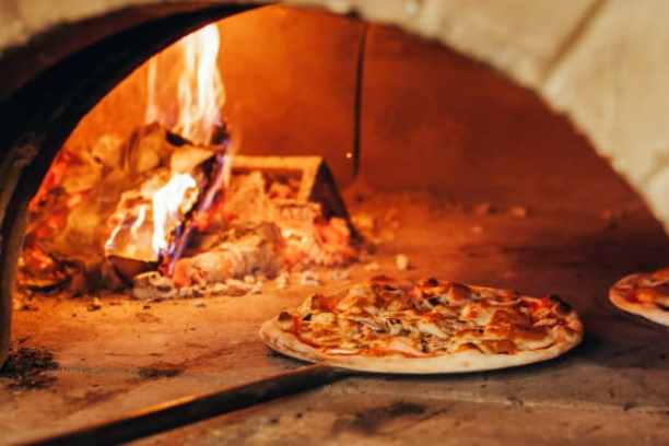a slice of pizza sitting on top of a stove