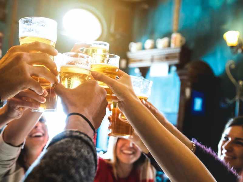 a group of people holding wine glasses