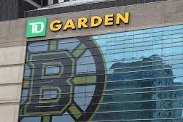 Exterior of TD Garden with a large Boston Bruins logo on the windows.